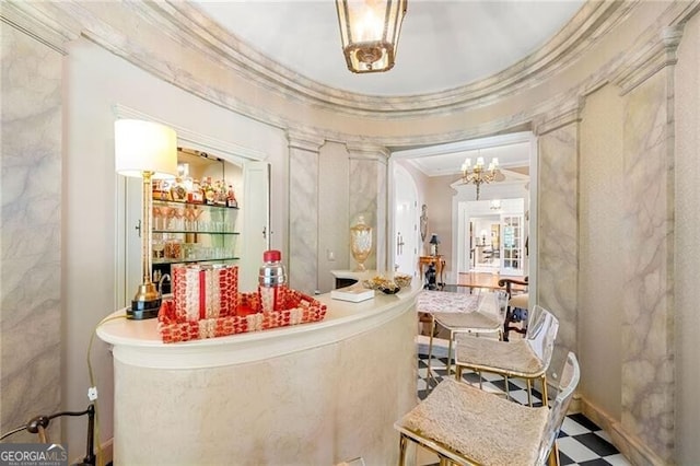 interior space featuring crown molding, a dry bar, a notable chandelier, and tile patterned floors