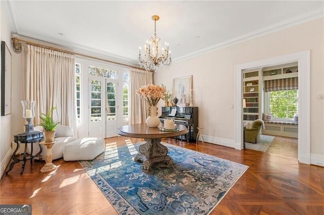 interior space with a chandelier, baseboards, crown molding, and a healthy amount of sunlight