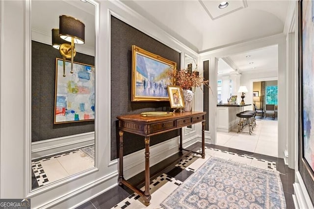 hallway featuring ornamental molding and tile patterned flooring