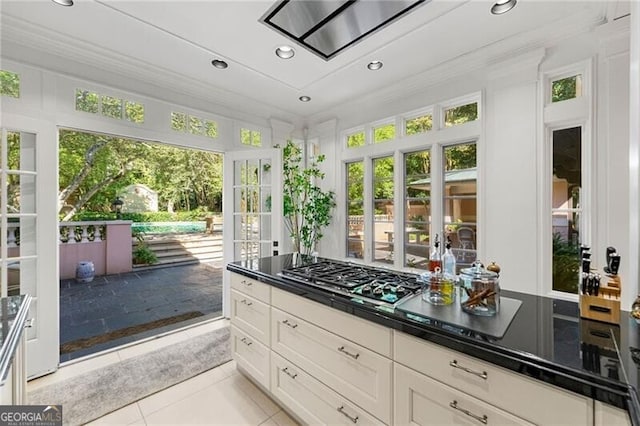 kitchen featuring french doors, a healthy amount of sunlight, stainless steel gas stovetop, and ornamental molding