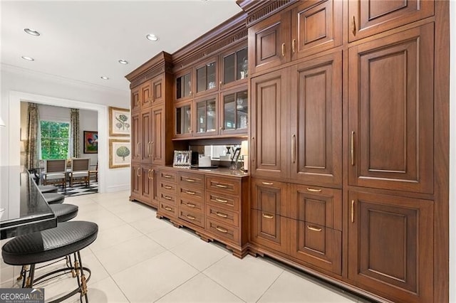 bar featuring crown molding, light tile patterned floors, and recessed lighting