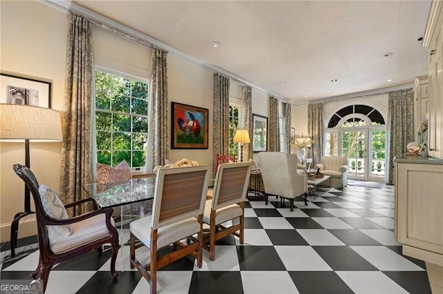 dining space featuring ornamental molding, plenty of natural light, and dark floors