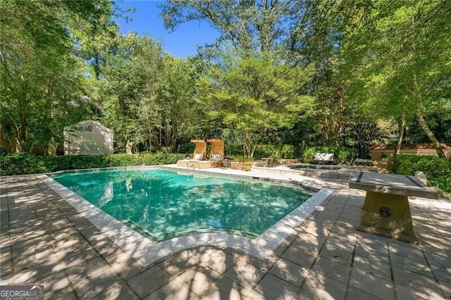 outdoor pool with a patio area