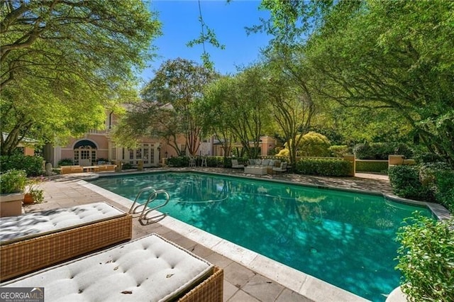 pool featuring french doors and a patio