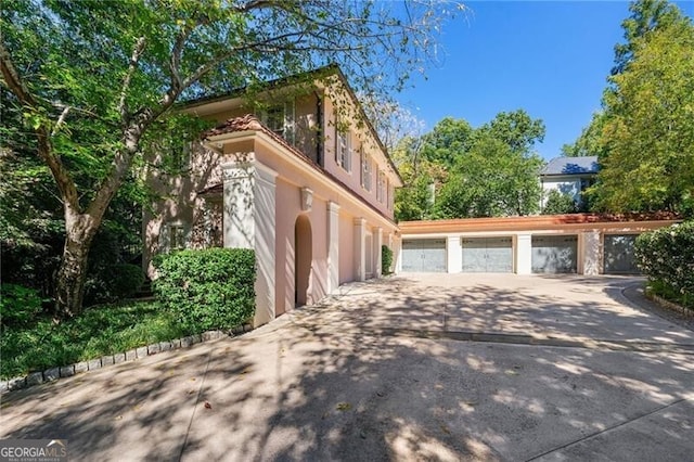 view of property exterior with driveway and stucco siding