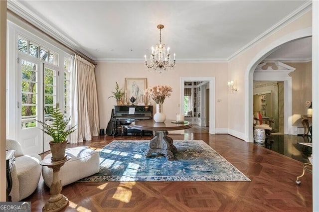 interior space with crown molding, baseboards, arched walkways, and a notable chandelier