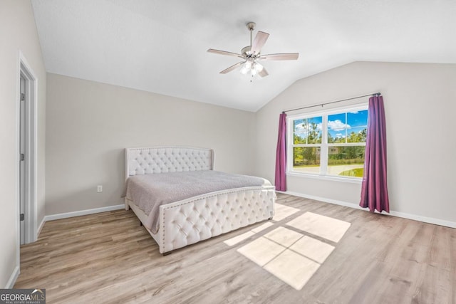 bedroom featuring baseboards, a ceiling fan, wood finished floors, and lofted ceiling