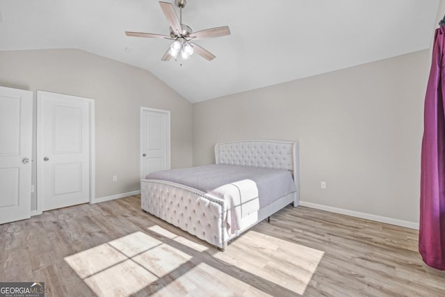 bedroom with baseboards, wood finished floors, a ceiling fan, and lofted ceiling
