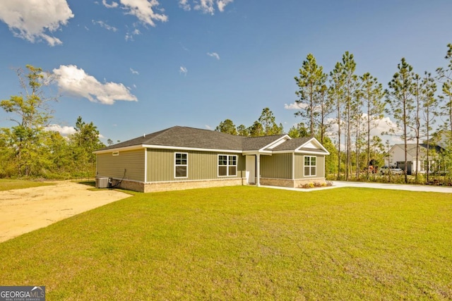 view of front of property featuring central AC unit and a front lawn