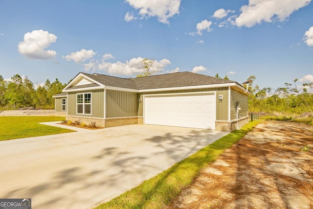 view of front of property with a front yard, a garage, concrete driveway, brick siding, and roof with shingles
