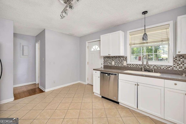 kitchen featuring a sink, decorative backsplash, dark countertops, and dishwasher