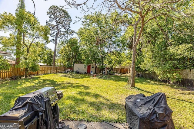 view of yard featuring a fenced backyard and an outdoor structure