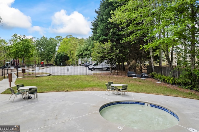 view of swimming pool featuring a patio, fence, and a lawn