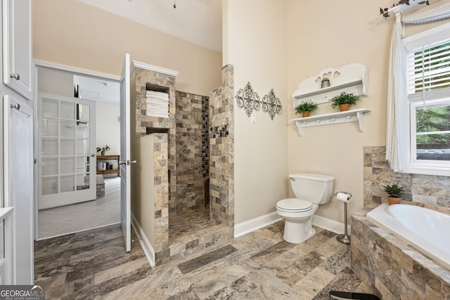 full bathroom featuring a walk in shower, baseboards, a garden tub, and toilet