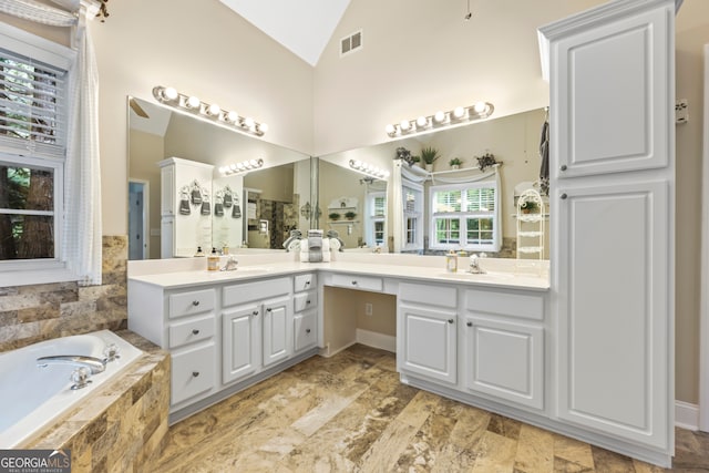 bathroom featuring high vaulted ceiling, a bath, vanity, a ceiling fan, and visible vents