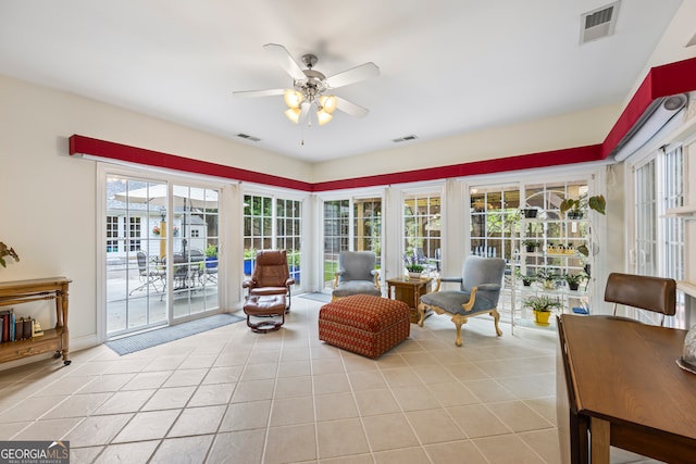 sitting room featuring visible vents, a ceiling fan, and light tile patterned floors