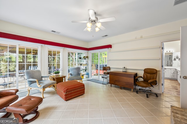 interior space with light tile patterned floors, visible vents, and a ceiling fan
