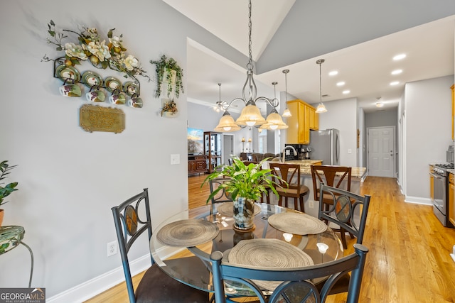 dining room featuring recessed lighting, light wood-style flooring, baseboards, and vaulted ceiling