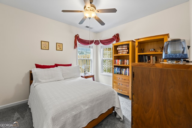 carpeted bedroom with visible vents, baseboards, and ceiling fan