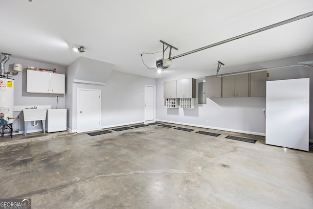 garage featuring water heater, a sink, a garage door opener, baseboards, and fridge