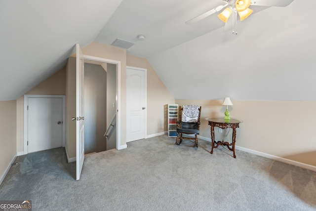 living area with carpet, visible vents, baseboards, and lofted ceiling