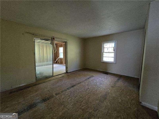 1846 Markone St NW, Atlanta, GA 30318 - carpeted spare room with a textured ceiling