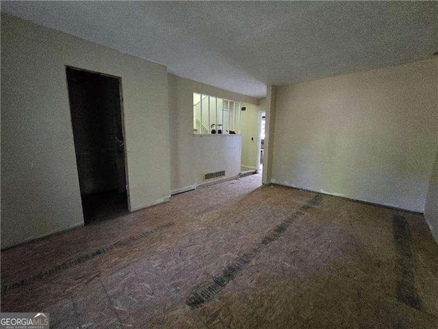 1846 Markone St NW, Atlanta, GA 30318 - spare room featuring a textured ceiling, carpet floors, and visible vents