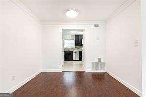 5672 Kingsport Dr Unit 4, Atlanta, GA 30342 - unfurnished room with baseboards, ornamental molding, and wood finished floors