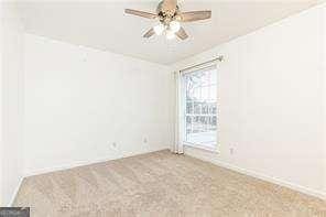 5672 Kingsport Dr Unit 4, Atlanta, GA 30342 - spare room with a ceiling fan and carpet