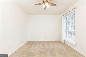 5672 Kingsport Dr Unit 4, Atlanta, GA 30342 - empty room featuring baseboards and ceiling fan