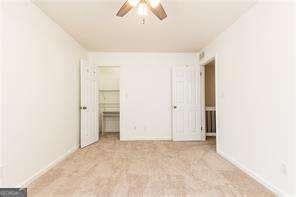 5672 Kingsport Dr Unit 4, Atlanta, GA 30342 - unfurnished bedroom with a closet and ceiling fan