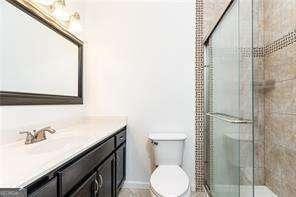 5672 Kingsport Dr Unit 4, Atlanta, GA 30342 - full bathroom featuring toilet, a stall shower, and vanity