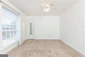 5672 Kingsport Dr Unit 4, Atlanta, GA 30342 - carpeted empty room with a ceiling fan
