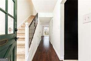 5672 Kingsport Dr Unit 4, Atlanta, GA 30342 - hallway featuring stairs and dark wood-type flooring