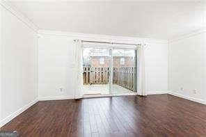5672 Kingsport Dr Unit 4, Atlanta, GA 30342 - empty room featuring ornamental molding and wood finished floors