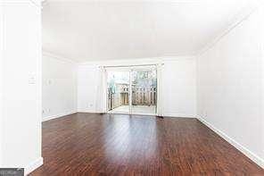 5672 Kingsport Dr Unit 4, Atlanta, GA 30342 - unfurnished living room with wood finished floors and ornamental molding
