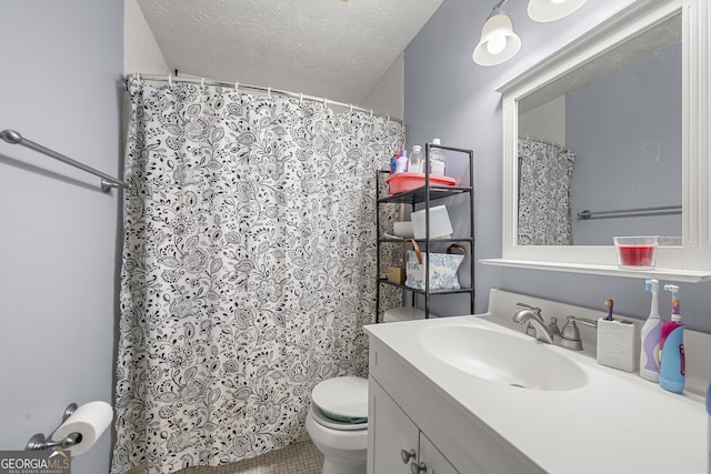 full bathroom with tile patterned flooring, toilet, vanity, a shower with shower curtain, and a textured ceiling
