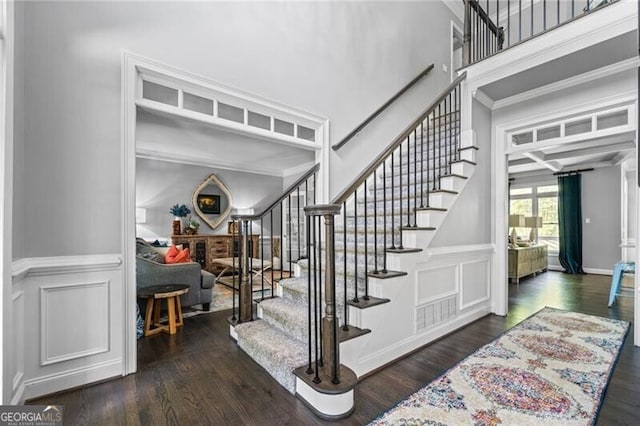 1326 Benbrooke Ln NW, Acworth, GA 30101 - stairs with a decorative wall, crown molding, a wainscoted wall, and wood finished floors