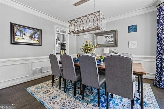 1326 Benbrooke Ln NW, Acworth, GA 30101 - dining space with a chandelier, crown molding, wainscoting, visible vents, and wood finished floors