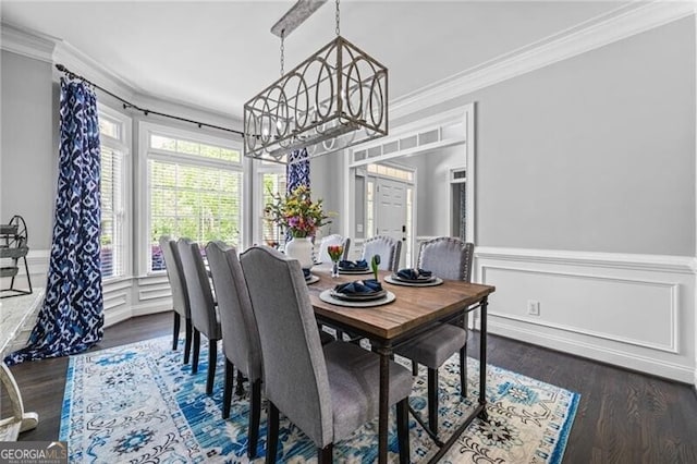 1326 Benbrooke Ln NW, Acworth, GA 30101 - dining space with crown molding, dark wood finished floors, an inviting chandelier, and wainscoting