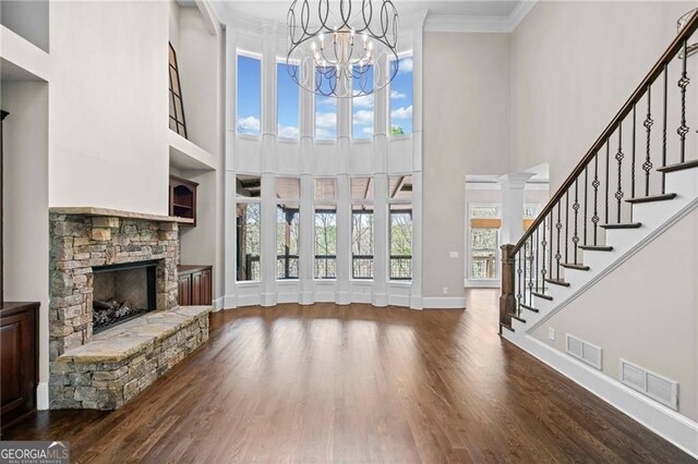 411 River Bluff Ln, Ball Ground, GA 30107 - unfurnished living room featuring wood finished floors, a fireplace, and visible vents
