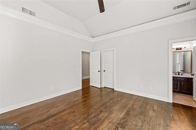 411 River Bluff Ln, Ball Ground, GA 30107 - unfurnished bedroom featuring visible vents, baseboards, vaulted ceiling, and wood finished floors