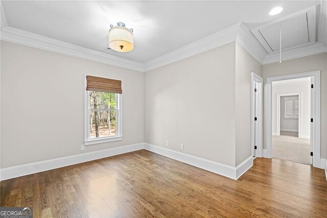 411 River Bluff Ln, Ball Ground, GA 30107 - spare room with ornamental molding, baseboards, attic access, and wood finished floors