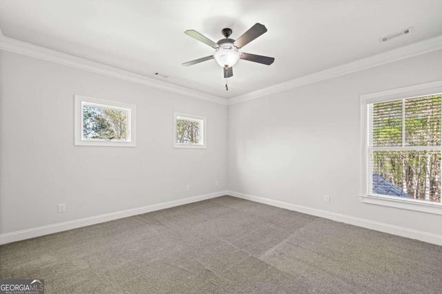 empty room with ornamental molding, visible vents, and a healthy amount of sunlight