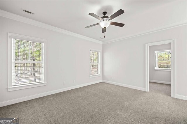 411 River Bluff Ln, Ball Ground, GA 30107 - empty room with crown molding, visible vents, plenty of natural light, and carpet floors