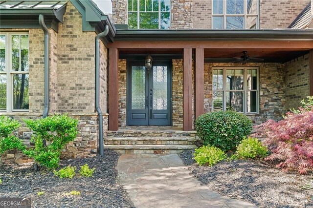 411 River Bluff Ln, Ball Ground, GA 30107 - property entrance featuring brick siding and french doors
