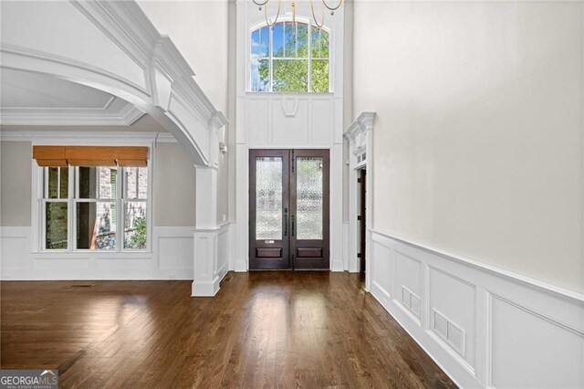 411 River Bluff Ln, Ball Ground, GA 30107 - foyer entrance with french doors, arched walkways, a decorative wall, and ornamental molding