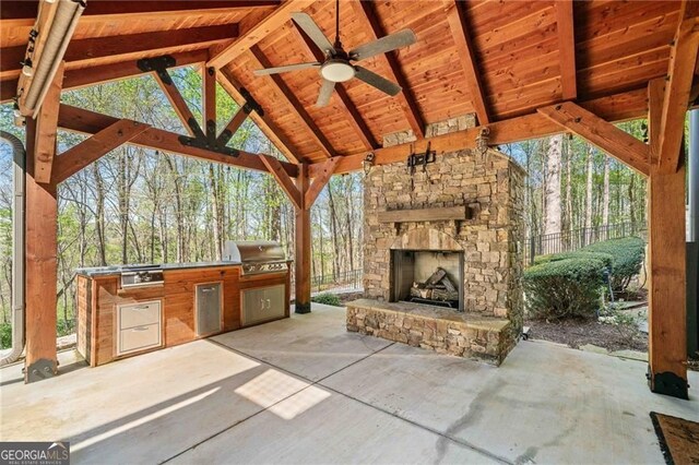 411 River Bluff Ln, Ball Ground, GA 30107 - view of patio / terrace featuring exterior kitchen, an outdoor stone fireplace, a grill, a gazebo, and fence