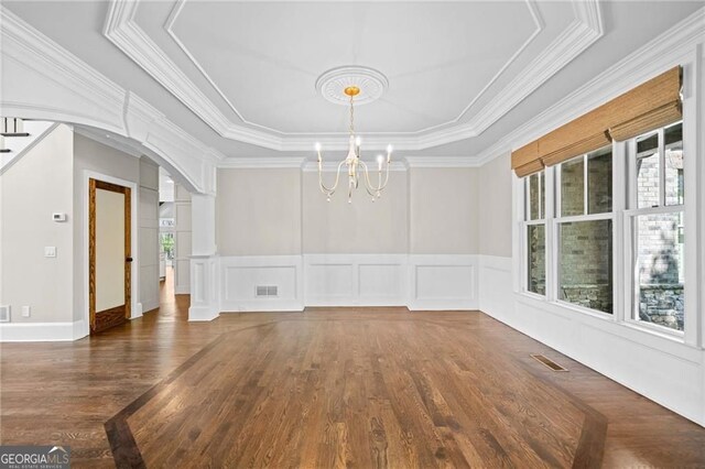 411 River Bluff Ln, Ball Ground, GA 30107 - unfurnished dining area featuring arched walkways, visible vents, an inviting chandelier, and wood finished floors