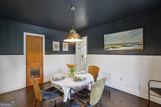 dining area featuring wood finished floors and baseboards